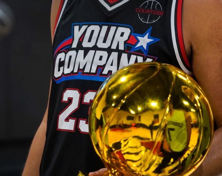 A player in a Your Company jersey holding a gold trophy